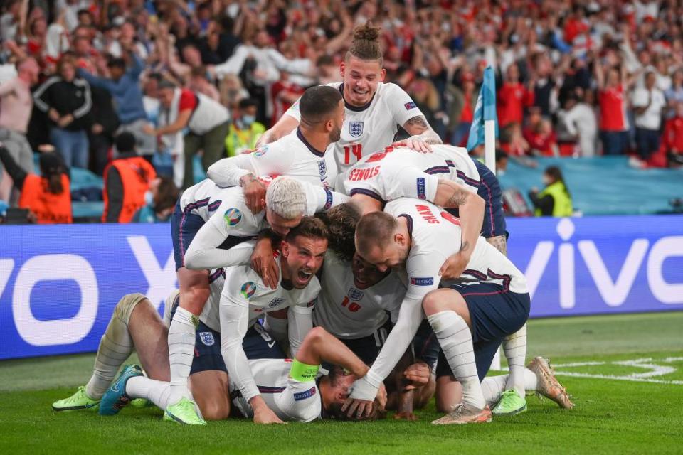 Harry Kane of England (obscured) celebrates with team mates after scoring their side’s second goal.