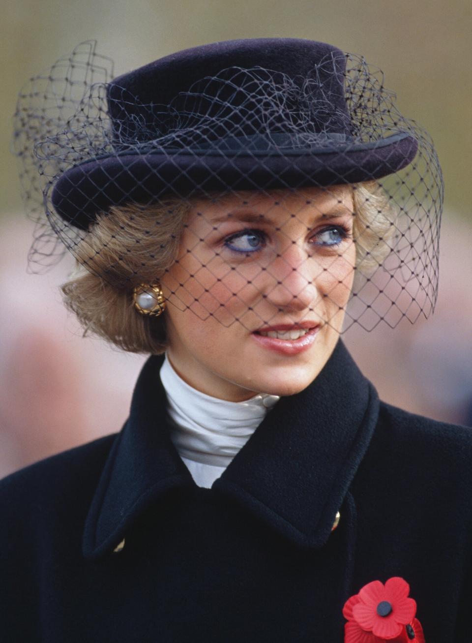 the Princess of Wales attends a service commemorating the 70th anniversary of the armistice, at the Arc de Triomphe in Paris, 11th November 1988. She is wearing a double breasted Jasper Conran coat, with a commemorative poppy, and a Viv Knowlands hat. (Photo by Jayne Fincher/Getty Images)