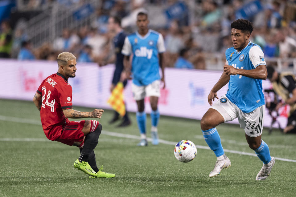 Charlotte FC defender Jaylin Lindsey, right, takes the ball past Toronto FC midfielder Lorenzo Insigne, left, during the first half of an MLS soccer match, Saturday, Aug. 27, 2022, in Charlotte, N.C. (AP Photo/Matt Kelley)