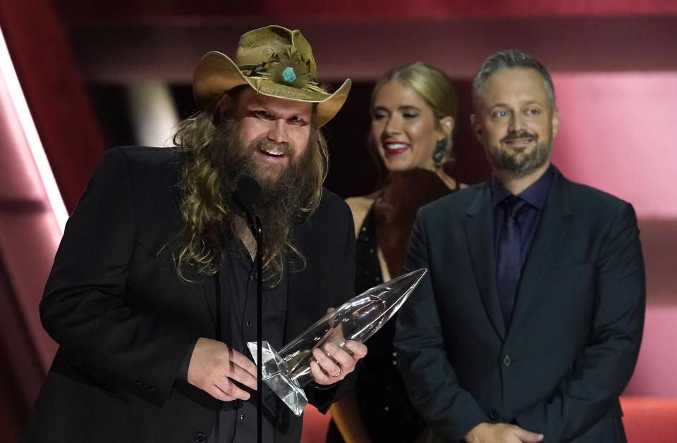 Chris Stapleton accepts the award for male vocalist of the year at the 57th Annual CMA Awards on Wednesday, Nov. 8, 2023, at the Bridgestone Arena in Nashville, Tenn. Nate Bargatze looks on from right.(AP Photo/George Walker IV)