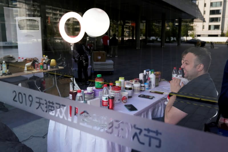 Two merchants perform in a live stream booth during Alibaba Group's 11.11 Singles' Day global shopping festival at the company's headquarters in Hangzhou