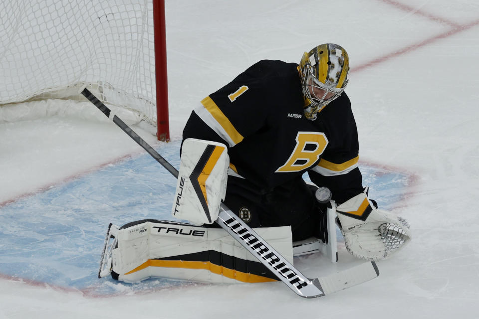Boston Bruins goaltender Jeremy Swayman (1) makes a save during the first period of an NHL hockey game against the Philadelphia Flyers, Monday, Jan. 16, 2023, in Boston. (AP Photo/Mary Schwalm)