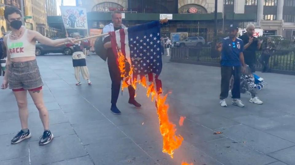 Protesters set US flags on fire and chanted “death to America” during Monday’s day of unrest. Katie Smith via Storyful