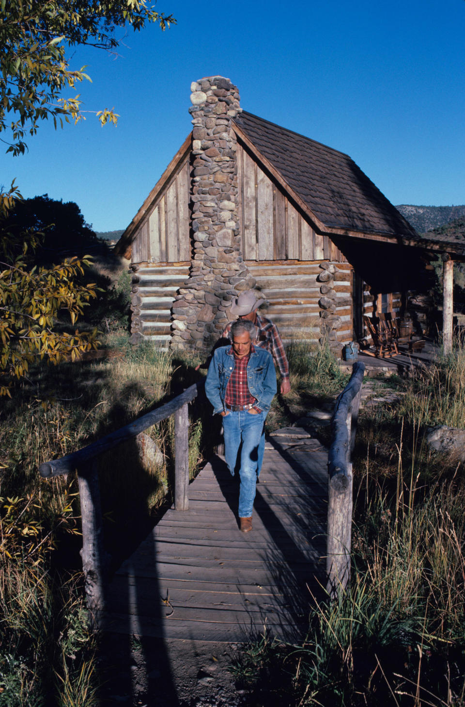 Fashion designer Ralph Lauren in front of the guest house or "cottage" on the "Double RL", Ralph Lauren's 10-thousand-acre ranch deep in the mountains of southern Colorado, Lauren's vision of the Western good life named for Ralph and his wife Ricky on October 7, 1985 in Ridgway, Colorado.