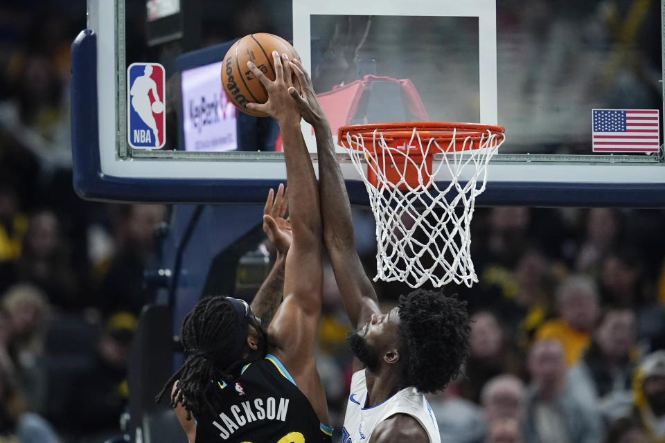 Indiana Pacers' Isaiah Jackson, left, has his shot blocked by Orlando Magic's Jonathan Isaac during the first half of an NBA basketball game Saturday, Dec. 23, 2023, in Indianapolis. (AP Photo/Darron Cummings)