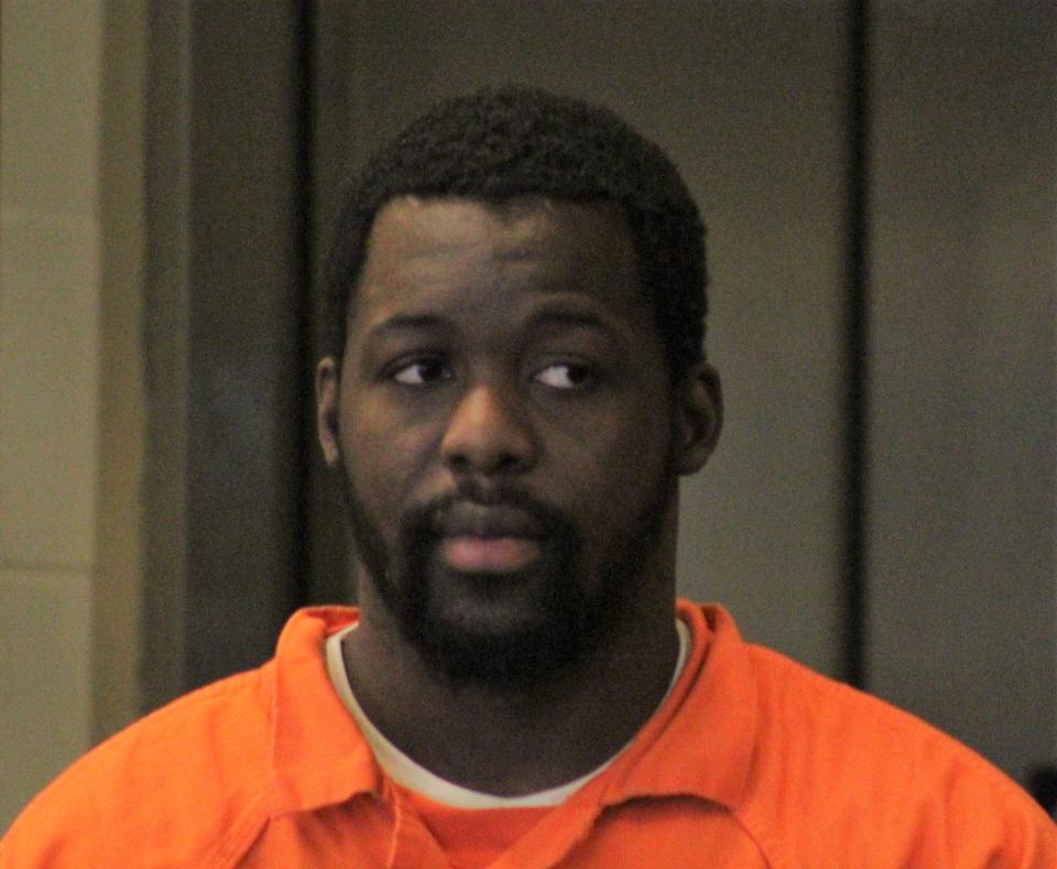 Kwentel Moultrie looks toward family members as he enters the courtroom for sentencing on Wednesday at the Kim C. Hammond Justice Center in Bunnell.