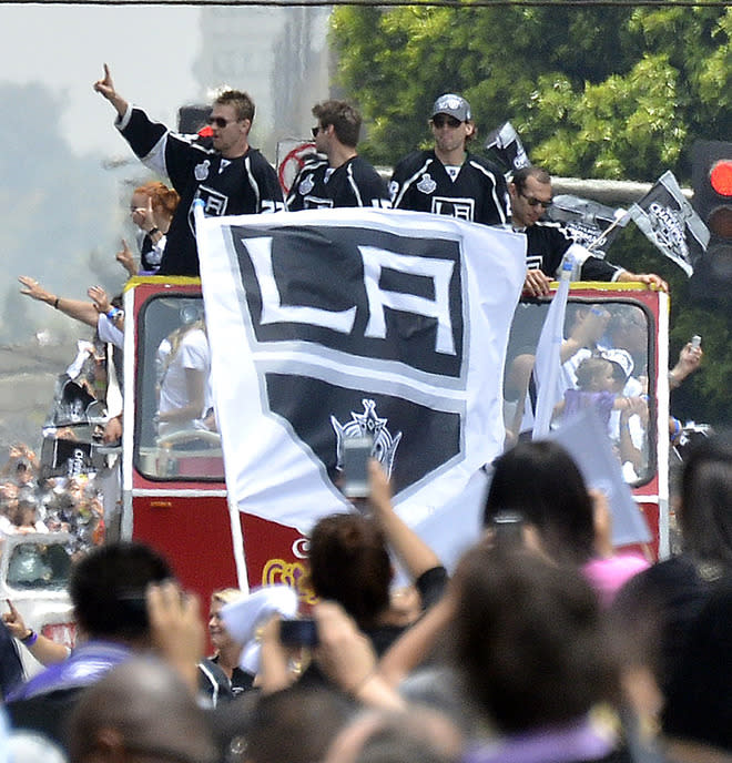 Buses with Los Angeles Kings team members, and their families travel Figueroa Street to the Staples Center during the Stanley Cup victory parade on June 14, 2012 in Los Angeles, California. The Kings are celebrating their first NHL Championship in the team's 45-year-old franchise history. AFP PHOTO/JOE KLAMARJOE KLAMAR/AFP/GettyImages