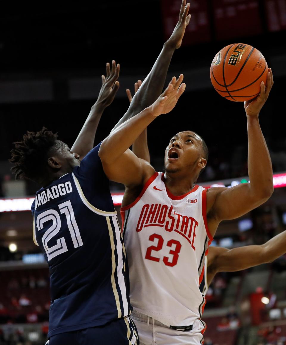 Ohio State Buckeyes forward Zed Key (23) maneuvers around Akron Zips center Aziz Bandaogo (21) Ohio State Buckeyes forward Zed Key (23) takes a shot aroiund Akron Zips center Aziz Bandaogo (21) during the first half of the NCAA men's basketball game at Value City Arena in Columbus on Tuesday, Nov. 9, 2021.