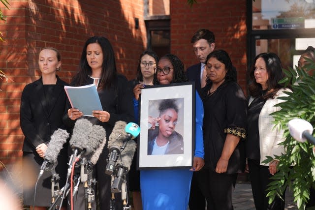 Hannah’s mother, Abimbola Duyile, holds a picture of her daughter as solicitor Michelle Victor outside East London Coroner’s Court following the conclusion of the inquest of 13-year-old Hannah Jacobs who died following a suspected anaphylactic reaction to a hot chocolate drink 