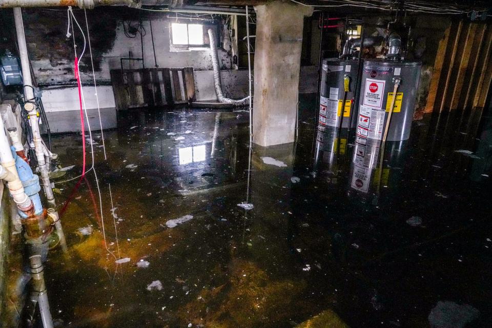 Water fills the basement of the house on Abbott Street in East Providence's Luther's Corner neighborhood where Kathy Ribeiro lived for 21 years before selling it to be demolished as part of a floodplain restoration project.