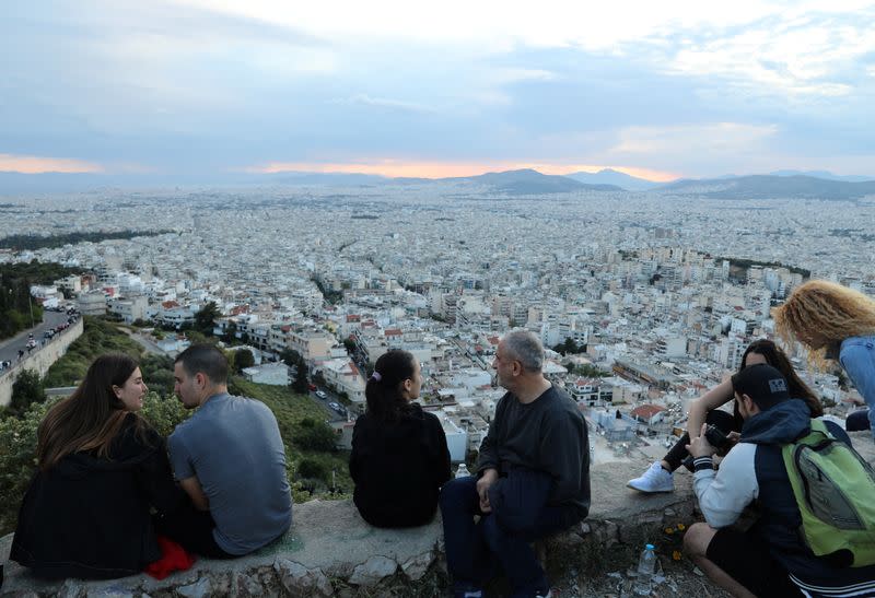 People sit overlooking Athens following the coronavirus disease (COVID-19) outbreak