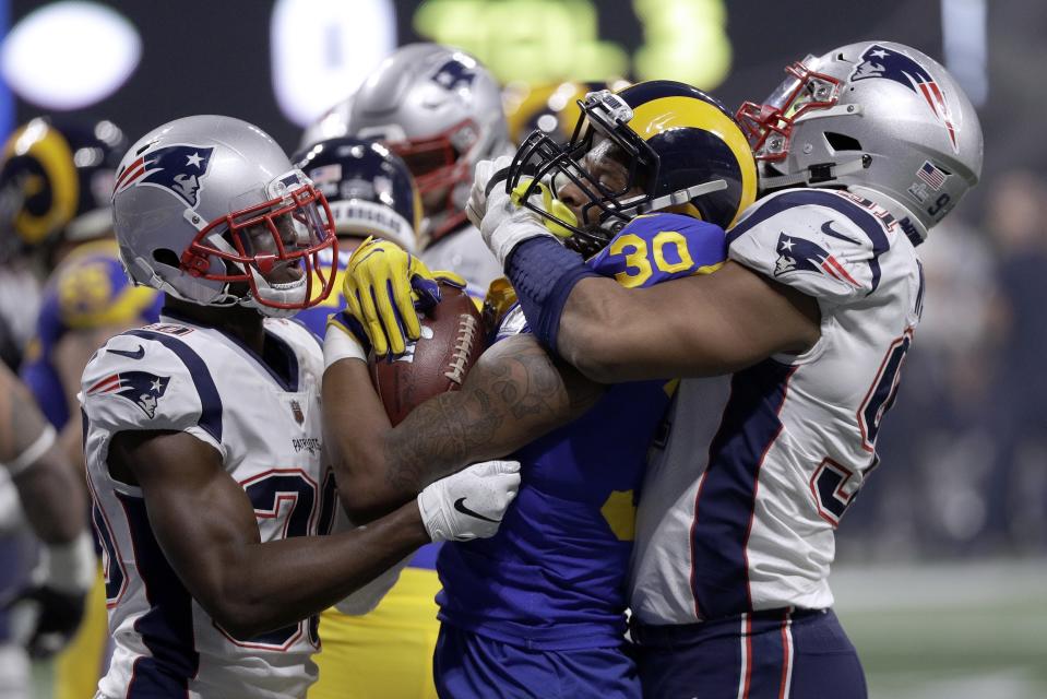 <p>Los Angeles Rams’ Todd Gurley II (30) is tackled by New England Patriots’ Jason McCourty, left, and Deatrich Wise Jr., right, during the second half of the NFL Super Bowl 53 football game Sunday, Feb. 3, 2019, in Atlanta. (AP Photo/David J. Phillip) </p>