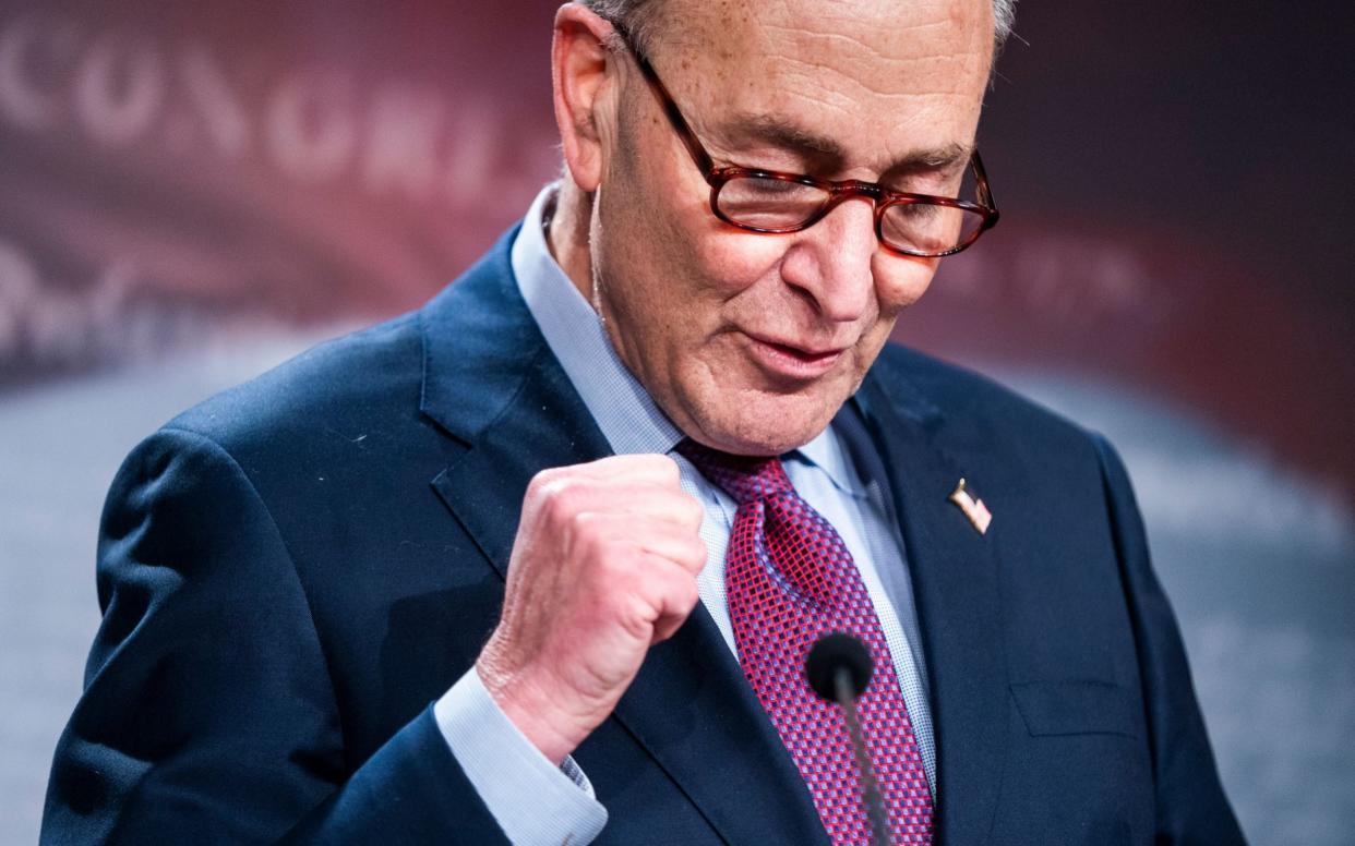 Senate Majority Leader Chuck Schumer celebrates the deal