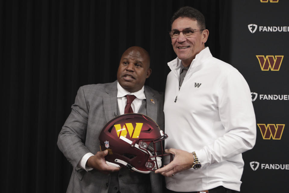 Eric Bieniemy, left, poses with Washington Commanders head coach Ron Rivera, right, after being introduced as the new offensive coordinator and assistant head coachof the Commanders during an NFL football press conference in Ashburn, Va., Thursday, Feb. 23, 2023. (AP Photo/Luis M. Alvarez)