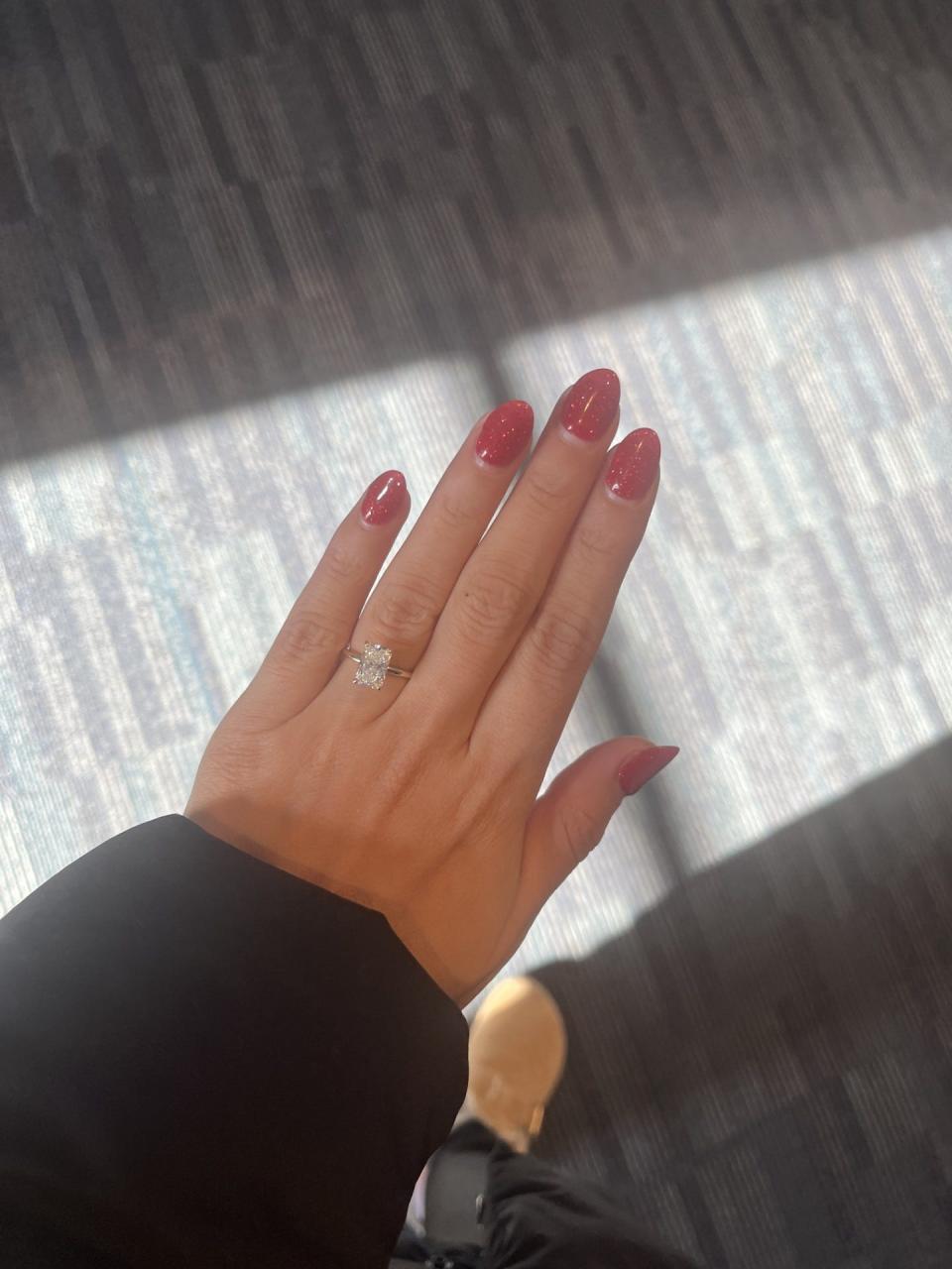 Vazquez has sparkly pink nails as she wears her diamond engagement ring