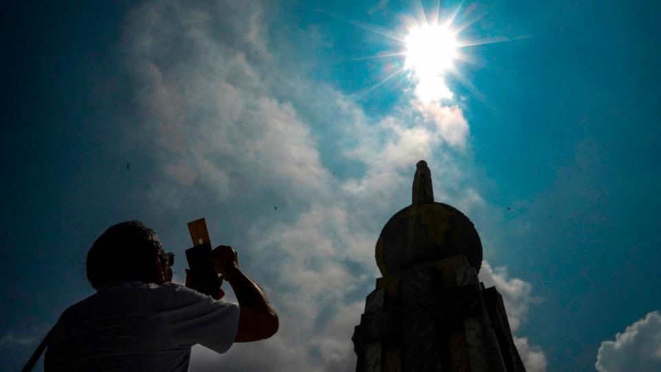 PHOTO: A man takes a picture of a partial solar eclipse in San Salvador. (Sopa Images/SOPA Images/LightRocket via Getty Images)