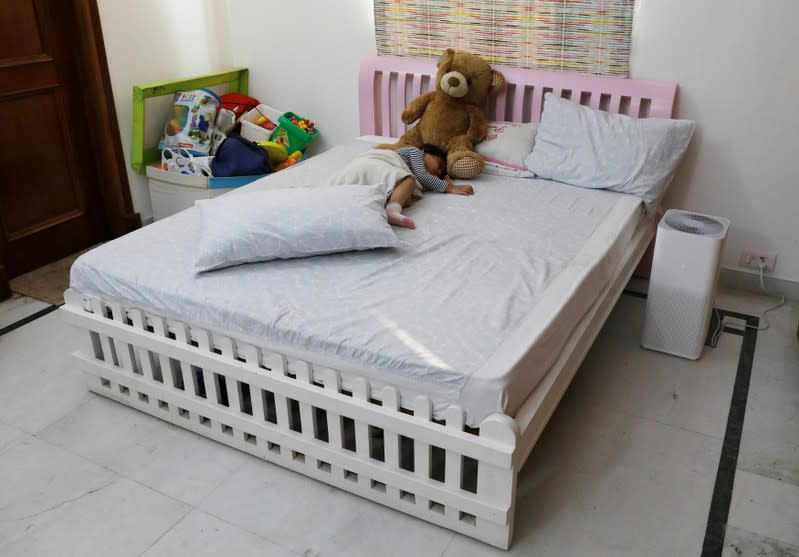 Mehreen, 3, daughter of Nabeela Moinuddin sleeps next to an air purifier inside her room at her house in New Delhi