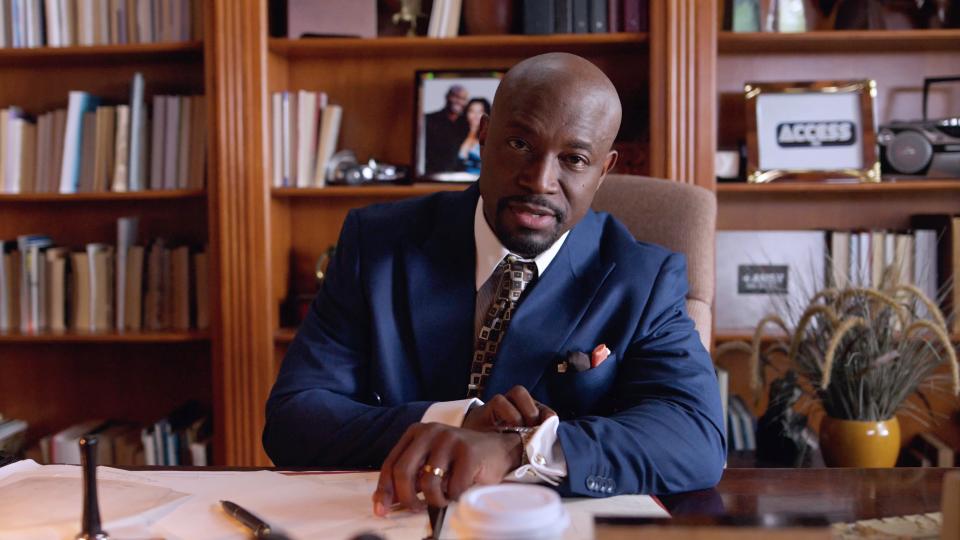 Taye Diggs as Lance sitting at a desk in Love & Murder: Atlanta Playboy