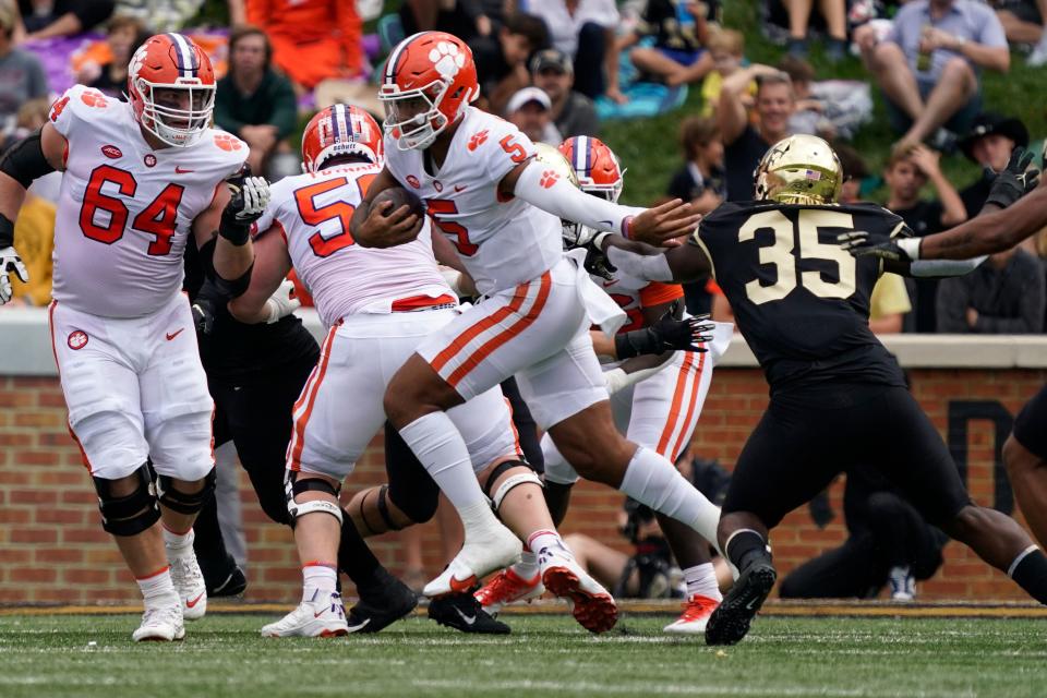 Clemson quarterback DJ Uiagalelei (5) runs past Wake Forest defensive lineman Kendron Wayman (35) during the first half at Winston-Salem, N.C., Saturday, Sept. 24, 2022.