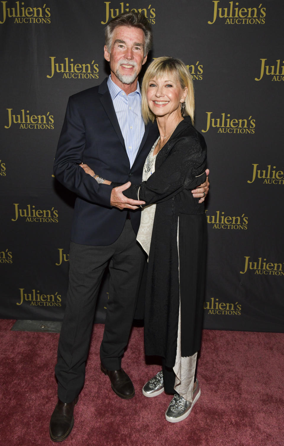 Olivia Newton-John and John Easterling pose at a VIP reception for the Property of Olivia Newton-John Auction Event at Julien's Auctions in 2019