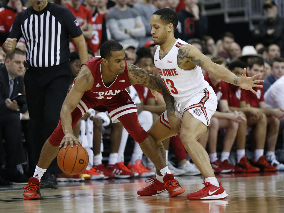 Indiana's Devonte Green, left, looks for an open pass as Ohio State's C.J. Walker defends during the second half of an NCAA college basketball game Saturday, Feb. 1, 2020, in Columbus, Ohio. Ohio State beat Indiana 68-59. (AP Photo/Jay LaPrete)