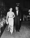 <p>Looking stunning in a metallic strapless and form-fitting gown, Jackie Kennedy walks with her husband, the first Roman Catholic elected as President of the United States. </p>