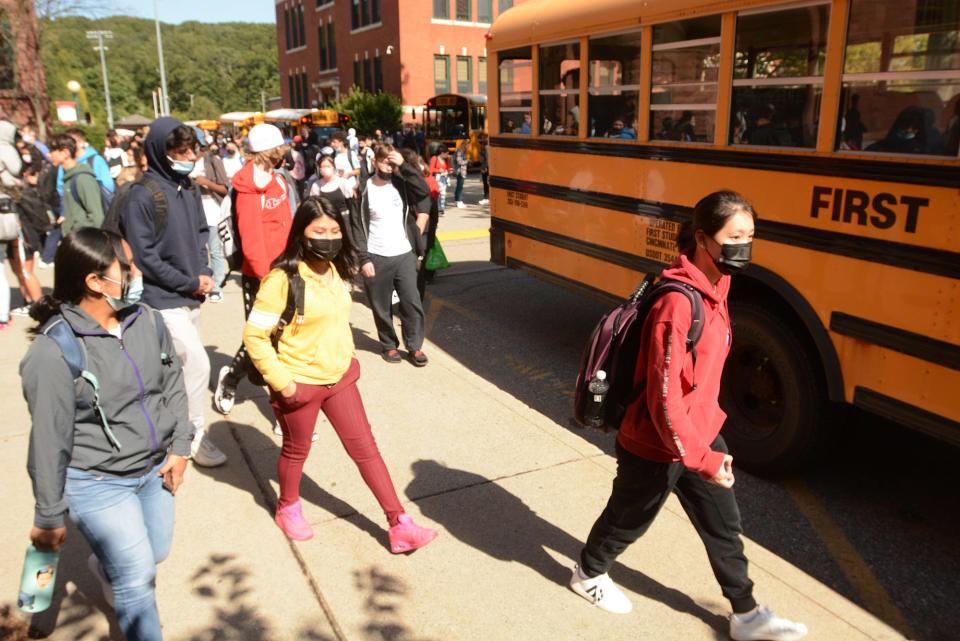 Norwich Free Academy students board their buses Monday after school in Norwich.