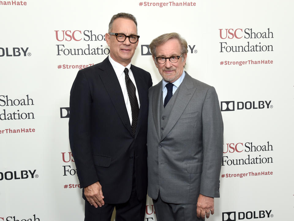 Closeup of Tom Hanks and Steven Spielberg smiling for photographers on the red carpet