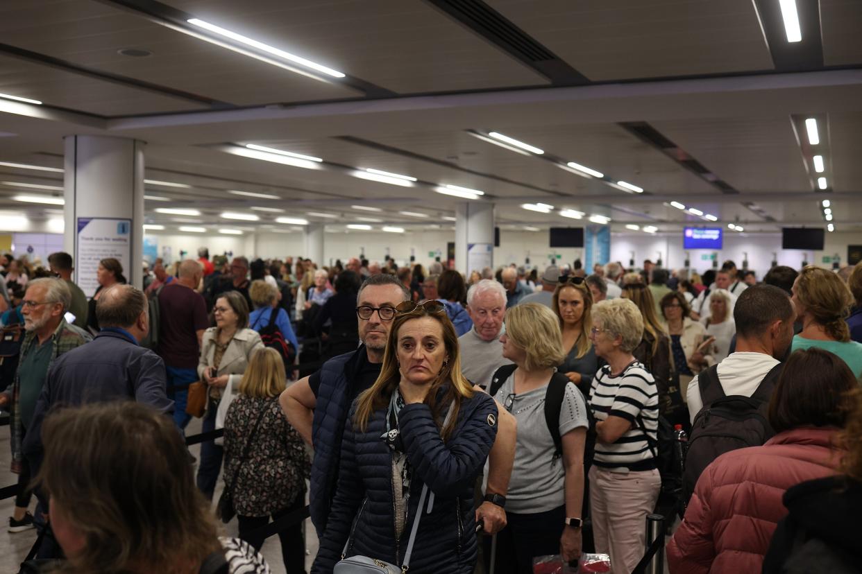 Passengers queue at Gatwick Airport as electronic passport gates fail across the UK (Getty Images)