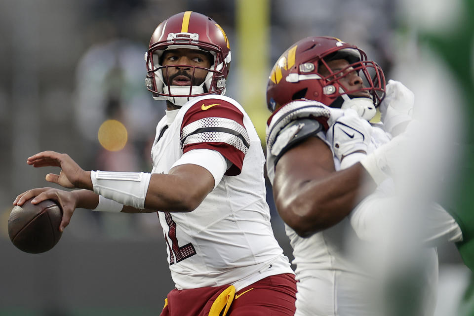 Washington Commanders quarterback Jacoby Brissett (12) passes against the New York Jets during the third quarter of an NFL football game, Sunday, Dec. 24, 2023, in East Rutherford, N.J. (AP Photo/Adam Hunger)