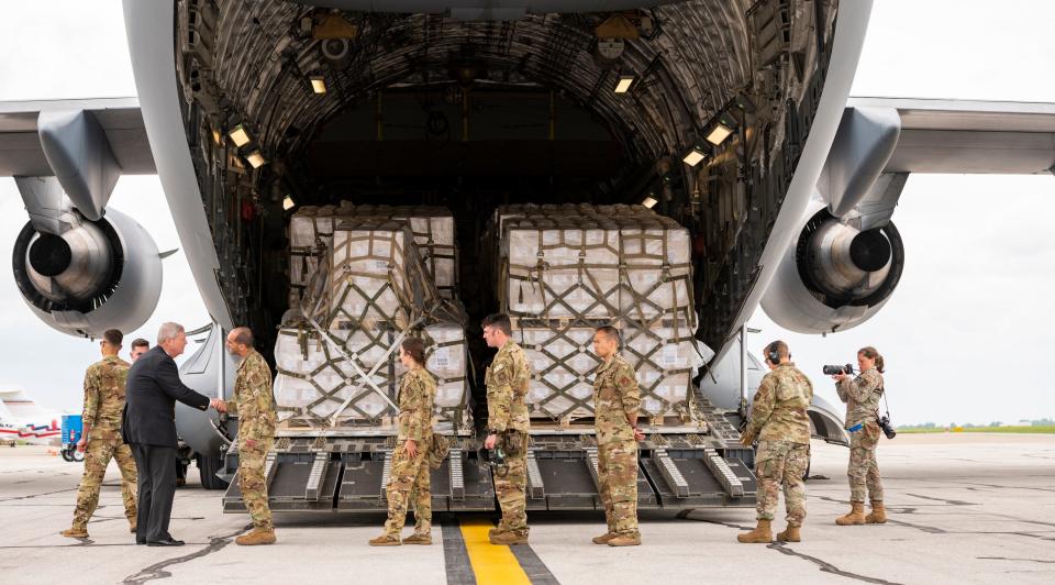 United States Secretary of Agriculture Tom Vilsack, left, greets crew members of an Air Force C-17 before they prepare to unload baby formula after its arrival from Ramstein Air Base in Germany. The arrival of the first shipment of formula brought to the United States under Operation Fly Formula in response to the infant formula shortage caused by Abbott Nutrition’s voluntary recall arrived at the Indianapolis International Airport, Sunday, May 22, 2022, on a Air Force C-17.