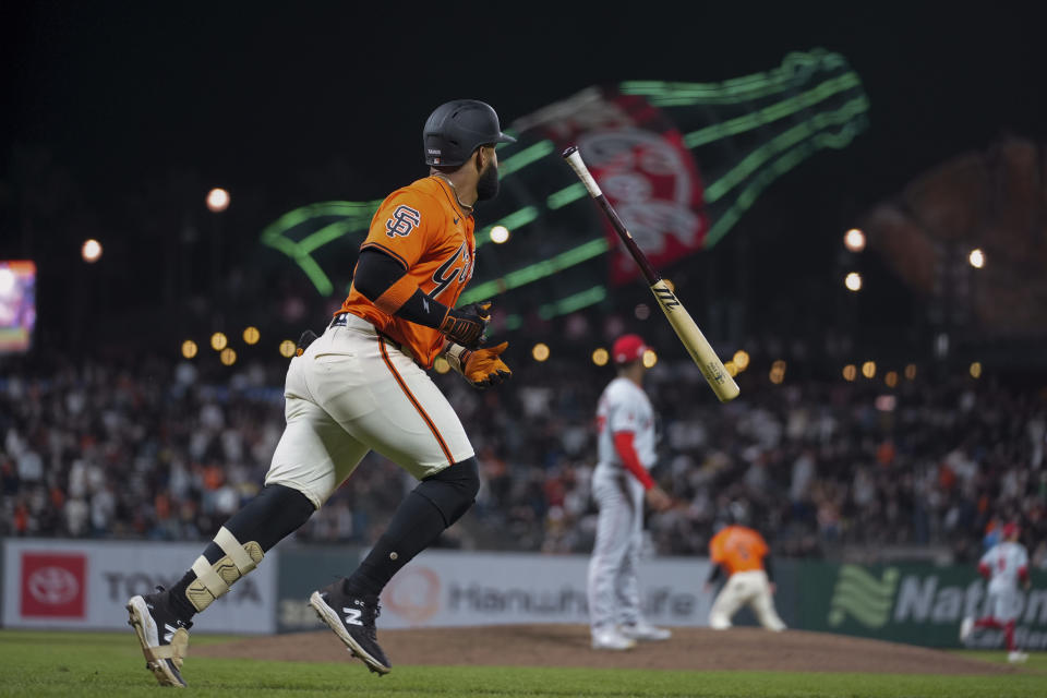 San Francisco Giants' Heliot Ramos, left, flips his bat after hitting a three-run home run against the Los Angeles Angels during the eighth inning of a baseball game Friday, June 14, 2024, in San Francisco. (AP Photo/Godofredo A. Vásquez)