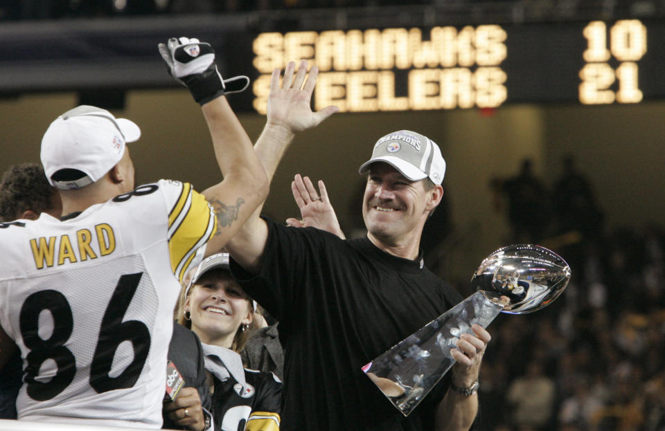 FILE - In this Sunday, Feb. 5, 2006 file photo, Pittsburgh Steelers head coach Bill Cowher high-fives Hines Ward (86), MVP of the Super Bowl XL football game, after they defeated the Seattle Seahawks, 21-10 in Detroit. Former Pittsburgh Steelers coach Bill Cowher has been elected to the Pro Football Hall of Fame. Cowher, an analyst for CBS, was surprised by the announcement made live on air in studio before the Tennessee Titans-Baltimore Ravens AFC divisional round playoff game Saturday night, Jan. 11, 2020. (AP Photo/Elaine Thompson, File)