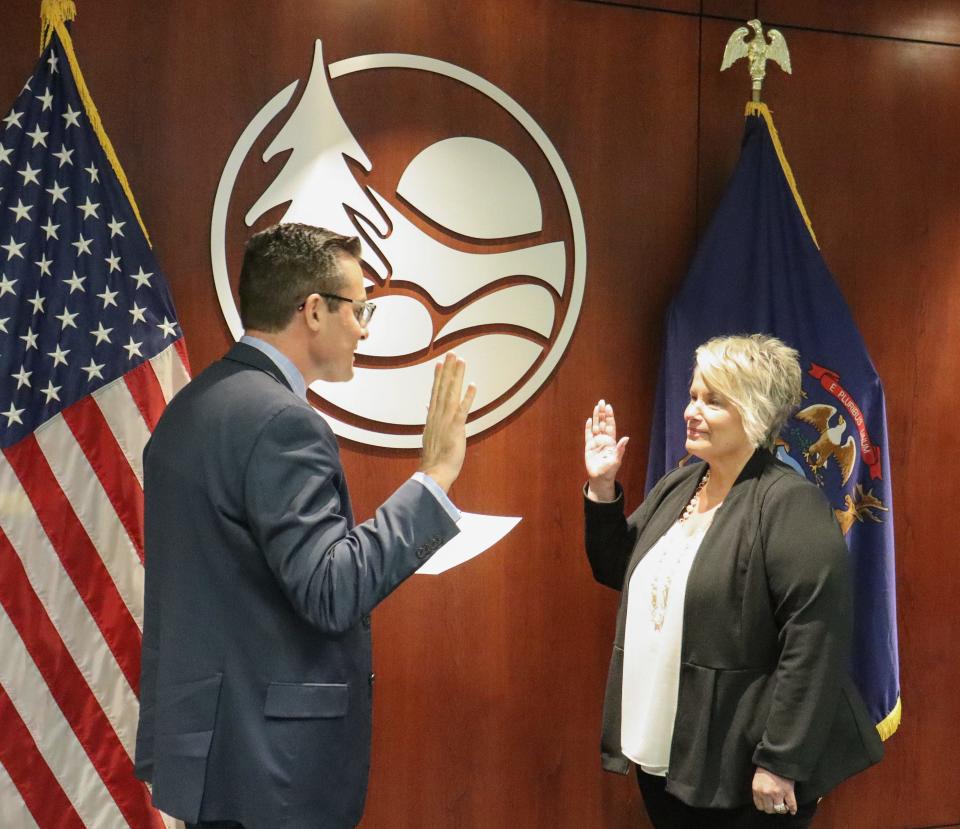 Ottawa County Commissioner Kendra Wenzel is sworn in by County Clerk Justin Roebuck on Tuesday, Dec. 12.