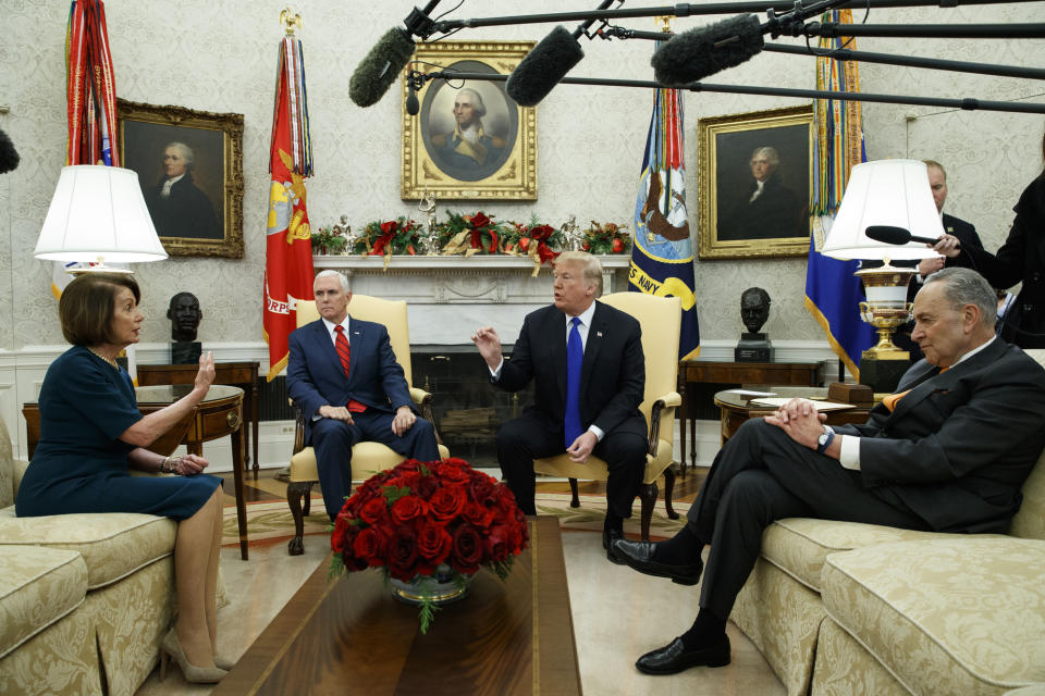 FILE - In this Tuesday, Dec. 11, 2018 file photo, House Minority Leader Rep. Nancy Pelosi, D-Calif., Vice President Mike Pence, President Donald Trump, and Senate Minority Leader Chuck Schumer, D-N.Y., argue during a meeting in the Oval Office of the White House in Washington. On Friday, Dec. 14, 2018, The Associated Press has found that stories circulating on the internet that Democrats gave a $150 billion payout from the U.S. treasury to Iran, are untrue. (AP Photo/Evan Vucci)