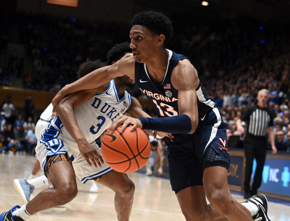Mar 2, 2024; Durham, North Carolina, USA; Virginia Cavaliers guard Ryan Dunn (13) drives to the basket a Duke Blue Devils guard <a class="link " href="https://sports.yahoo.com/ncaab/players/158513/" data-i13n="sec:content-canvas;subsec:anchor_text;elm:context_link" data-ylk="slk:Jeremy Roach;sec:content-canvas;subsec:anchor_text;elm:context_link;itc:0">Jeremy Roach</a> (3) defends during the first half at Cameron Indoor Stadium. Rob Kinnan-USA TODAY Sports