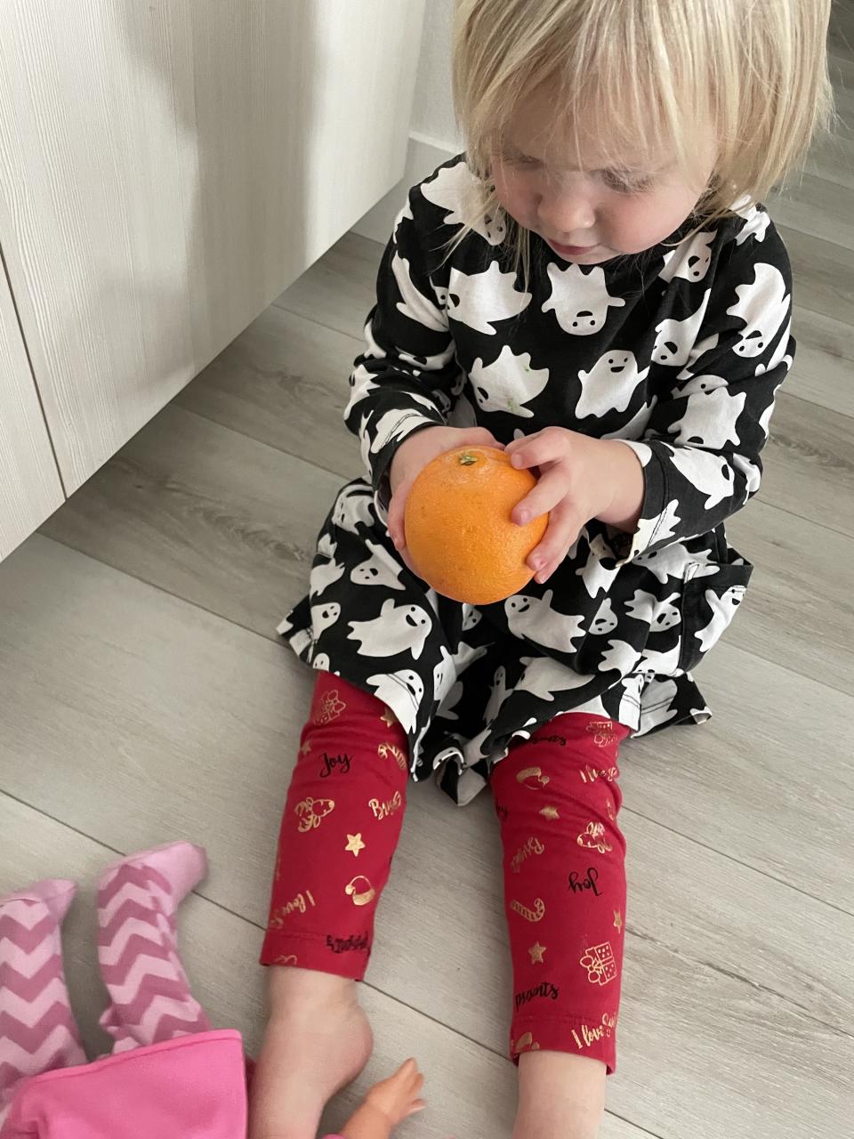 the authors daughter peeling an orange