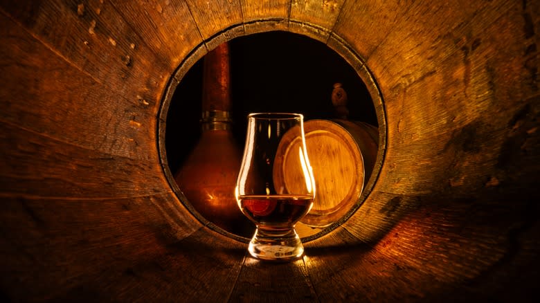 Whiskey glass in a barrel