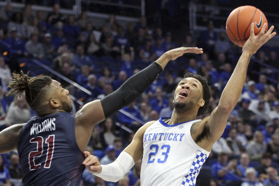 Kentucky's EJ Montgomery (23) shoots while defended by Fairleigh Dickinson's Elyjah Williams (21) during the first half of an NCAA college basketball game in Lexington, Ky., Saturday, Dec. 7, 2019. (AP Photo/James Crisp)