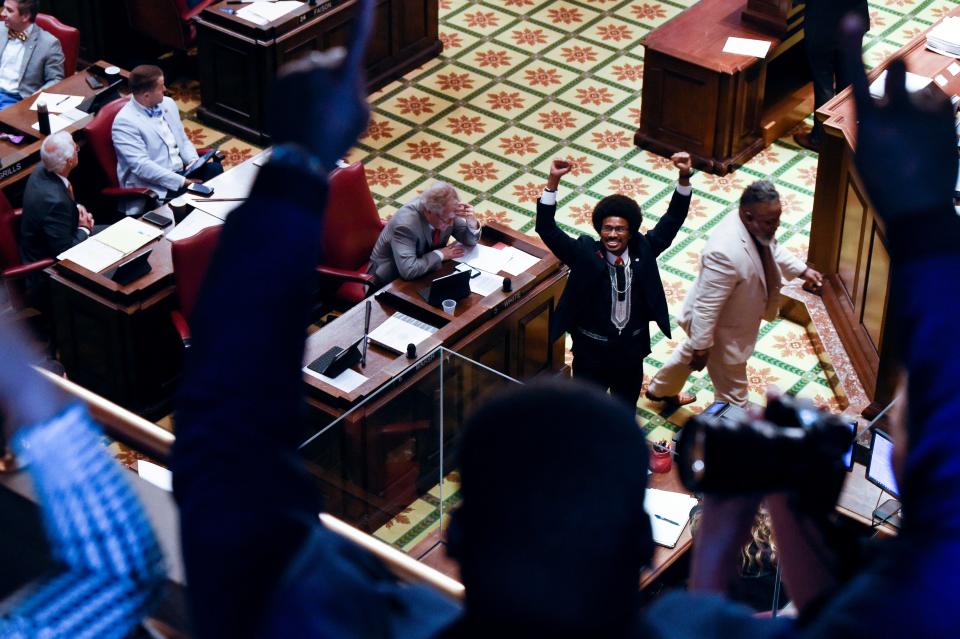 Justin Pearson, D-Memphis, signals to his supporters in the gallery as he returns to the State Capitol in Nashville, Tenn., on Thursday, April 13, 2023, after he reappointed to the Tennessee House of Representatives.