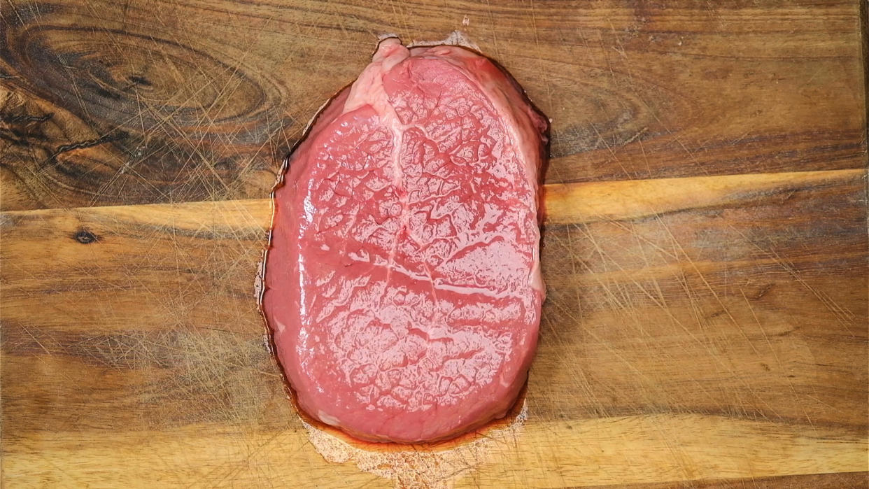  A raw steak on a wooden board - Header image for Sean McCormack opinion piece on shooting in Raw. 