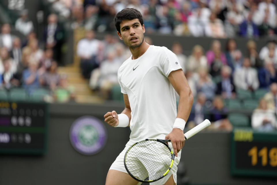 Spain's Carlos Alcaraz celebrates after winning a point against Jeremy Chardy of France in a first round men's singles match on day two of the Wimbledon tennis championships in London, Tuesday, July 4, 2023. (AP Photo/Kirsty Wigglesworth)