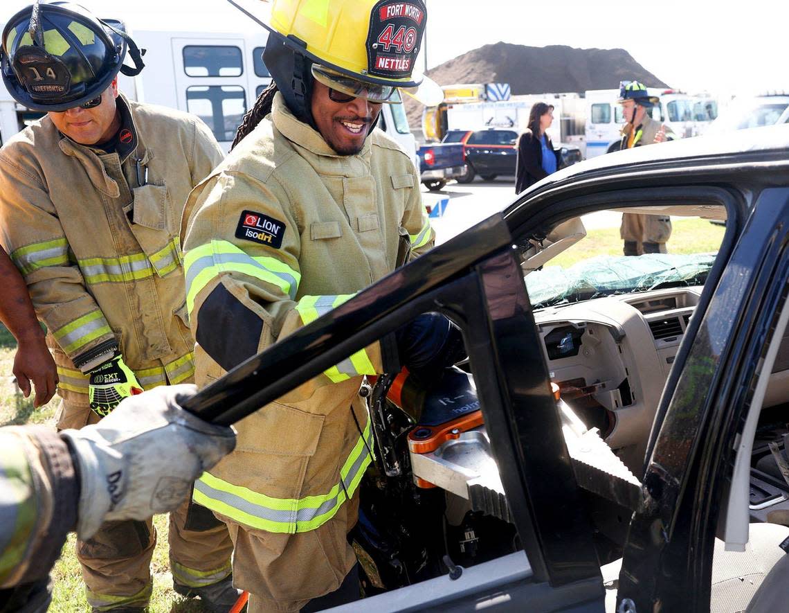 Fort Worth District 8 City Councilmember Chris Nettles learns how to use a tool for extracting victims from vehicles on Friday. City officials were invited to participate in a training session to learn what firefighters face on a day-to-day basis. Amanda McCoy/amccoy@star-telegram.com