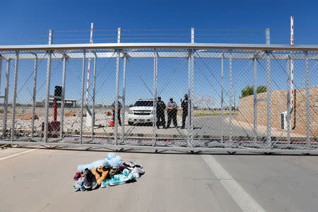 A pile of kids shoes left by mayors from U.S. cities lay at the front gate outside of the children's tent encampment built to deal with the Trump administrations "zero tolerance" policy in Tornillo, Texas. REUTERS/Mike Blake