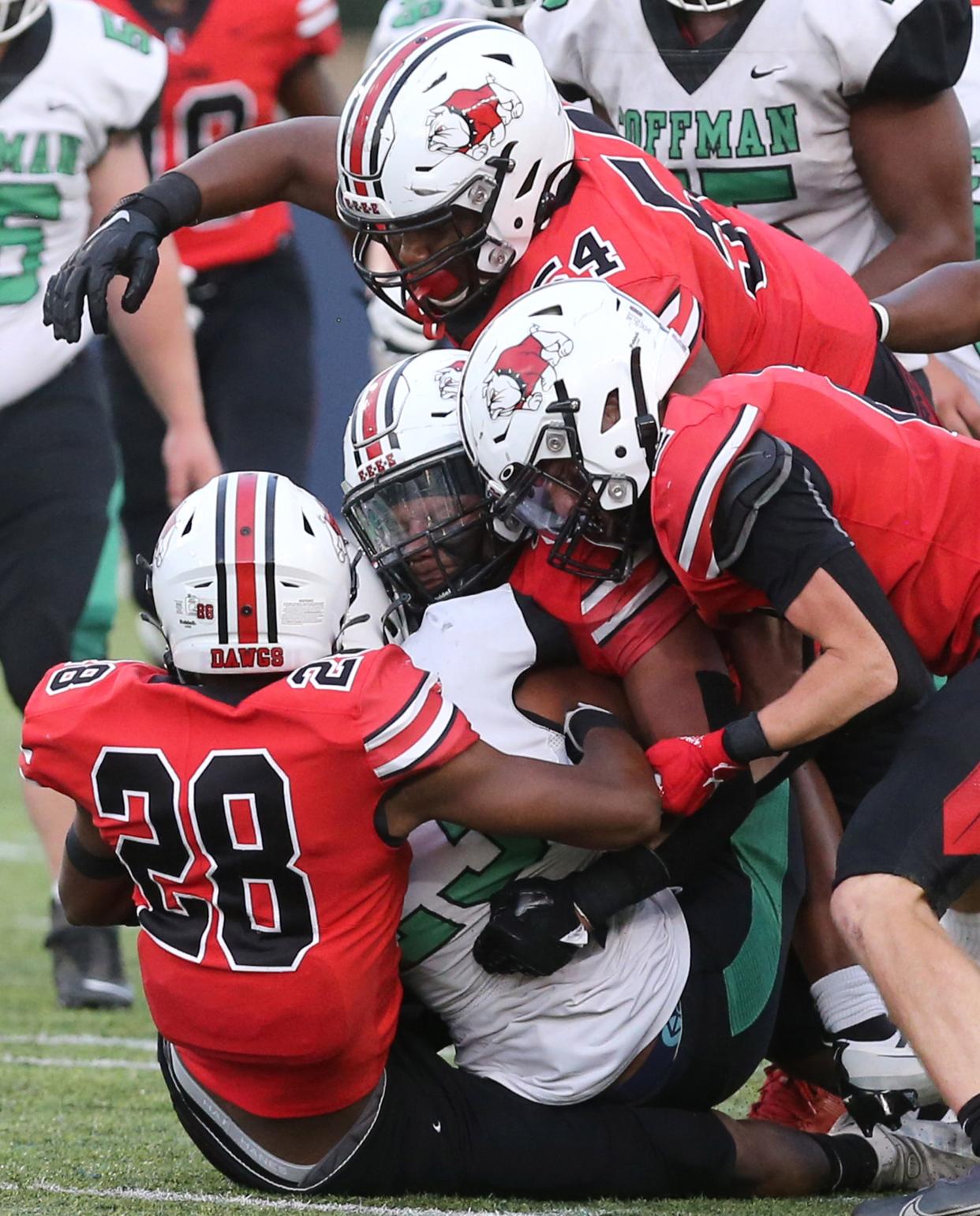 McKinley's Dior Garner (54, top) joins teammates Ja'Diss Jackson (28) and Alex Vazquez to tackle Daven White of Dublin Coffman last season.