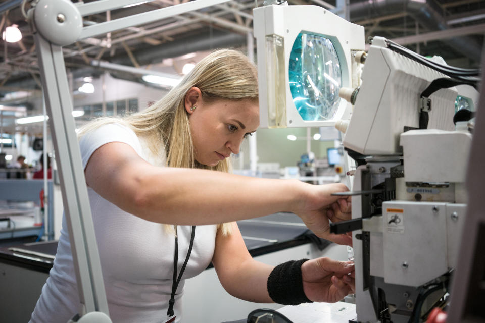 UK manufacturing: An employee at sewing machine in a factory