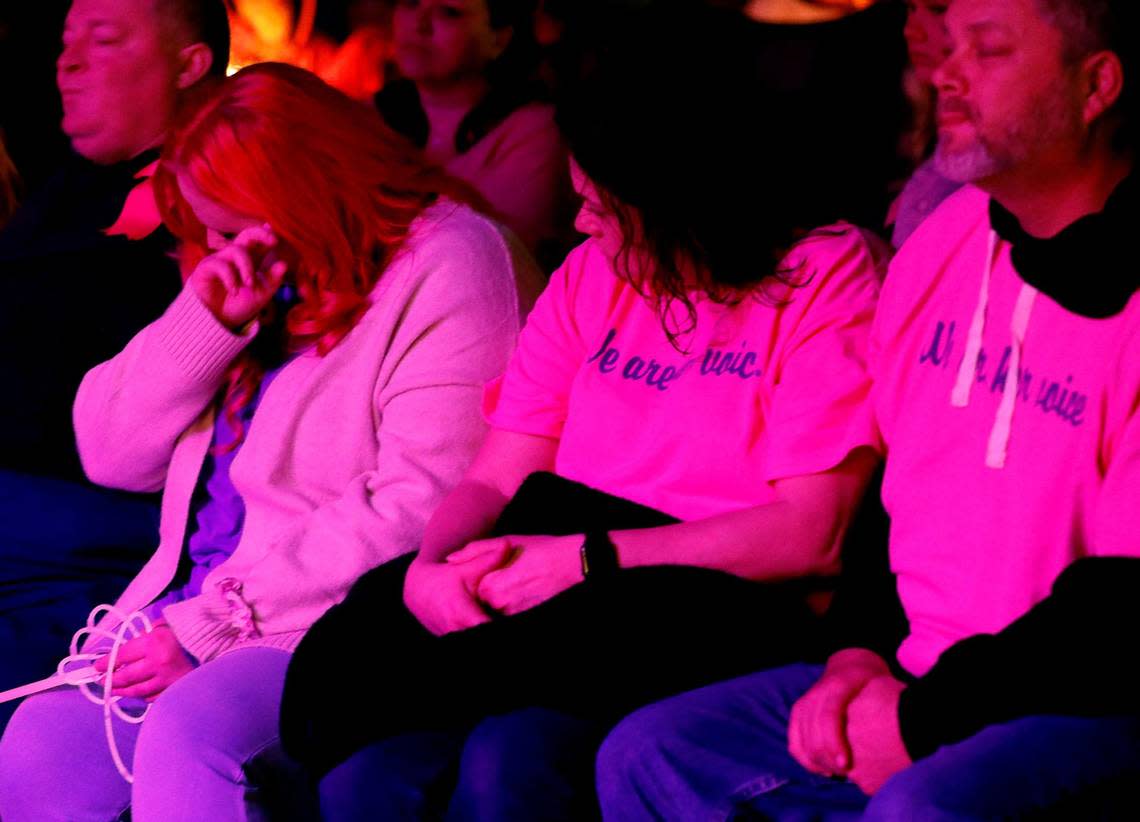 Athena Strand’s mother Maitlyn Presley Gandy wipes a tear away as she sits with other family members during a vigil for 7-year-old Athena Strand at the First Baptist Church of Cottondale on Tuesday. About 2,500 people attended her vigil.