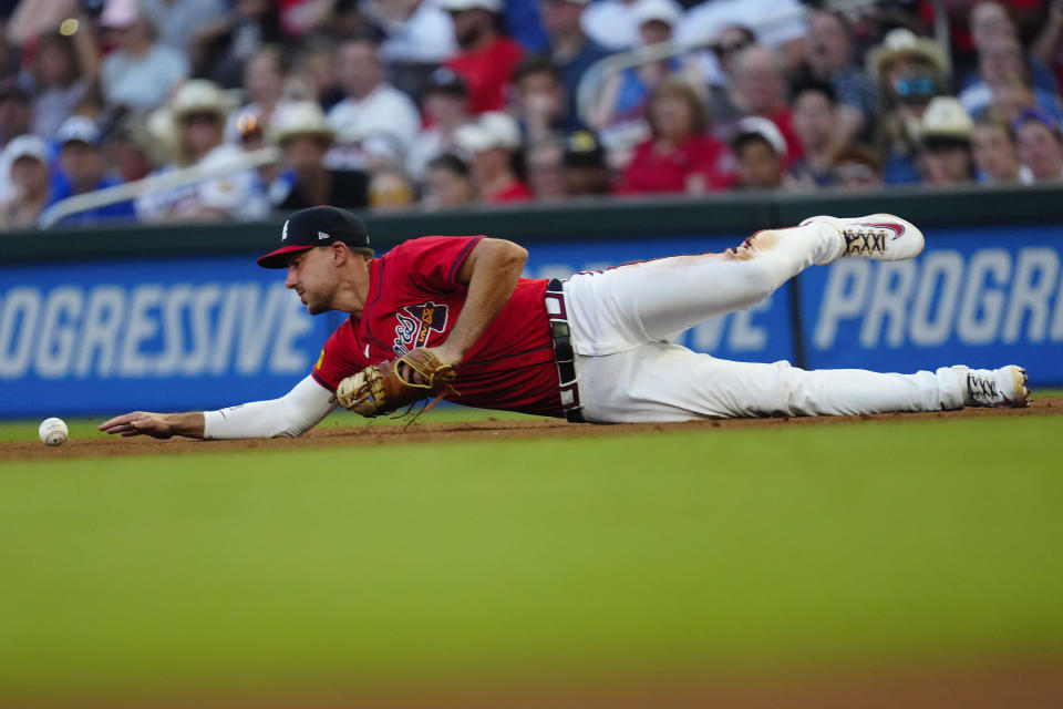 Atlanta Braves first baseman Matt Olson can not reach a ball hit for a single by Tampa Bay Rays' Isaac Paredes in the fourth inning of a baseball game Friday, June 14, 2024, in Atlanta. (AP Photo/John Bazemore)