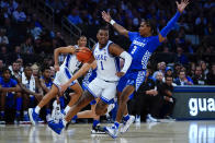 Duke's Trevor Keels (1) drives past Kentucky's TyTy Washington (3) during the first half of an NCAA college basketball game Tuesday, Nov. 9, 2021, in New York. (AP Photo/Frank Franklin II)