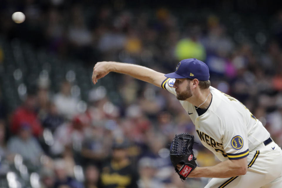 Milwaukee Brewers' Adrian Houser pitches during the first inning of the team's baseball game against the Pittsburgh Pirates on Tuesday, Aug. 3, 2021, in Milwaukee. (AP Photo/Aaron Gash)